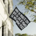 When The Power Of Love Beats The Love Of Power Flag on a building